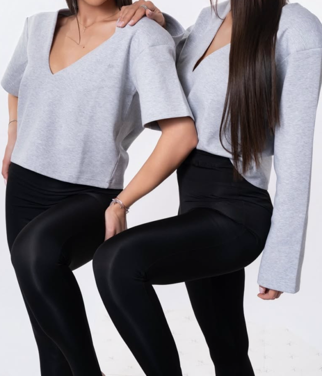 Grey structured scuba top with padded shoulders and deep V-neck